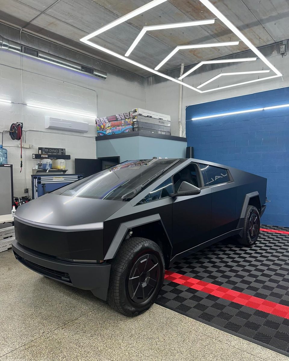 Satin-finish Tesla Cybertruck in the Stealth Customs bay